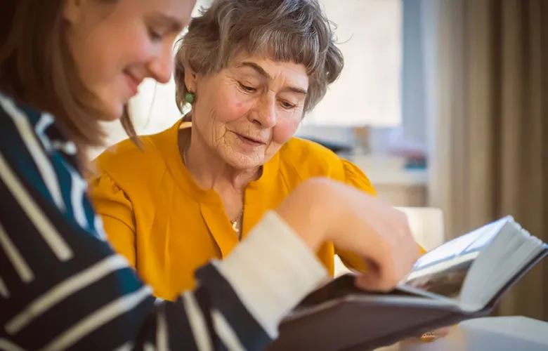 MemoryCare - Phoenix Senior Living Resident looking at Photo Album